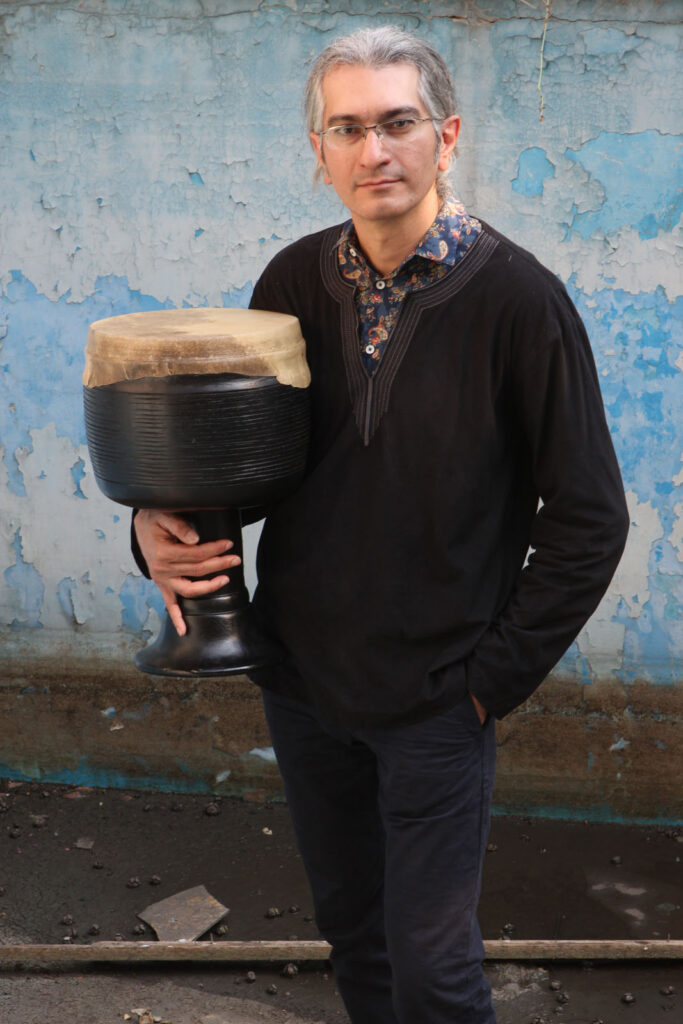 Farid Kheradmand standing with a Tombak